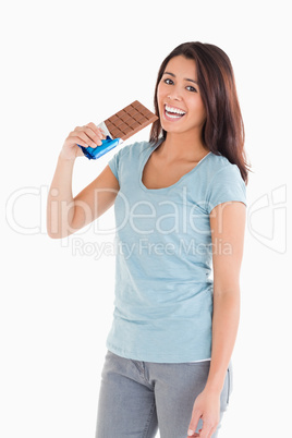 Beautiful woman eating a chocolate bar