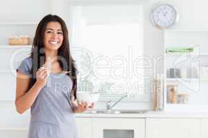 Charming woman enjoying a bowl of cereals while standing