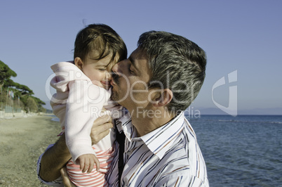 Baby with her Father on the Beach