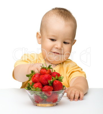 Happy little girl with strawberries
