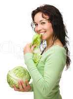 Beautiful young girl with green cabbage