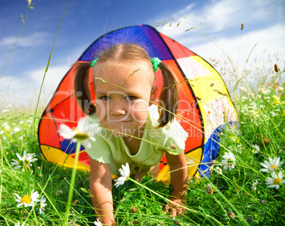 Girl is playing outdoors under tent