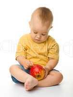 Cute little boy with red apple