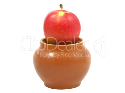 Fresh red apple in a clay pot.