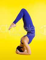 woman doing yoga exercise - head stand