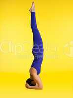 woman doing yoga exercise - head stand