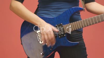 Young woman plays  blue guitar