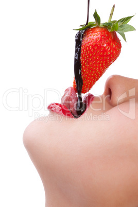 girl eating strawberry with chocolate sauc