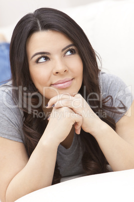 Beautiful Hispanic Woman Laying on Sofa Relaxing & Smiling