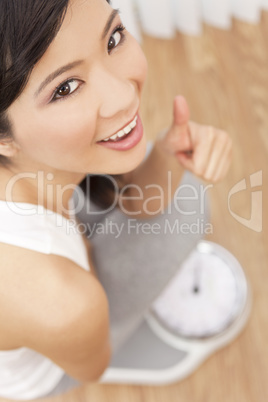 Asian Chinese Woman Thumbs Up Weighing Herself on Scales