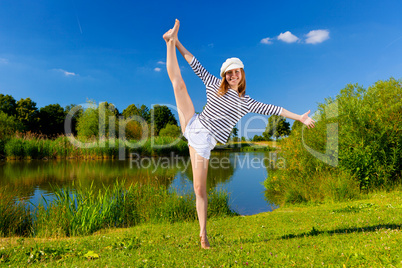 young woman exercising outdoor in summer