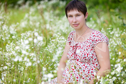 Pregnant woman in chamomile background