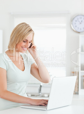 Blonde woman with a laptop and a phone