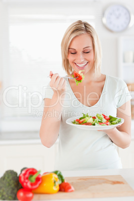 Young woman eating salad