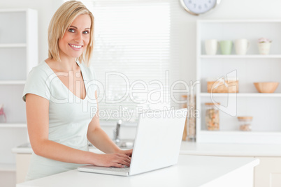 Charming woman with a laptop looking into the camera