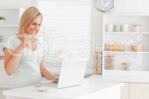 Woman with a cup of coffee and a laptop