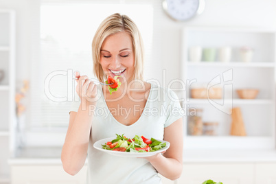 Gorgeous woman eating salad