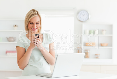 Cute woman smiling at her mobile