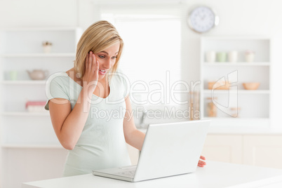 Amazed woman looking at notebook