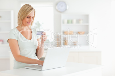 Woman with credit card and notebook