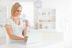 Woman with credit card and notebook
