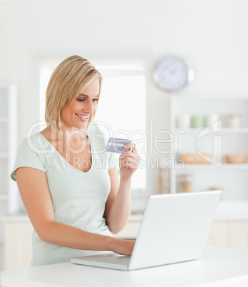 Blonde woman with credit card and notebook Blonde woman with credit card and notebook