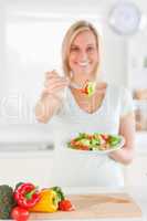 Young woman offering salad