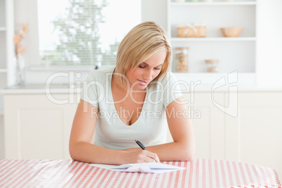 Woman sitting at a table writing a letter