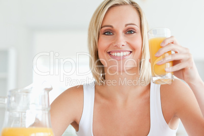 Woman toasting with orange juice