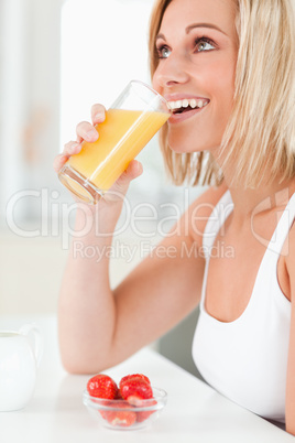 Woman drinking glass of orange juice