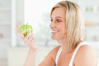 Young woman looking at green a apple