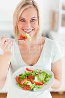 Charming woman eating salad