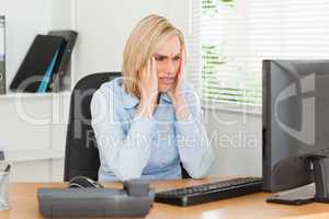 Frustrated working woman in front of a screen