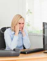 Frustrated working woman looking at a screen