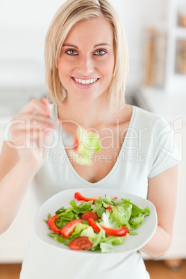 Cute woman offering salad