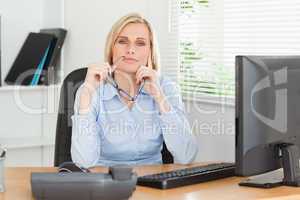 Thoughtful woman with glasses looking into camera