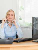 Serious thoughtful woman with glasses looking into camera