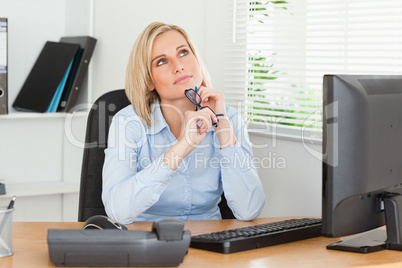 Thinking beauty behind a desk