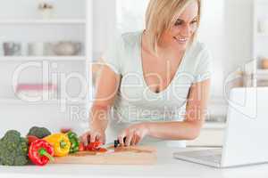 Close up of a woman looking for a recipe on laptop