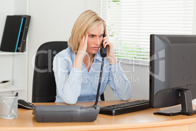 Charming  businesswoman on phone looking at screen while having