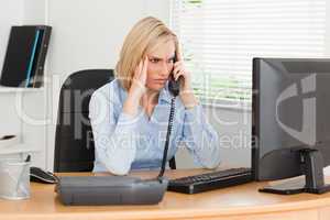 Charming  businesswoman on phone looking at screen while having