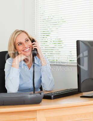 Cheerful businesswoman on phone looks at the ceiling