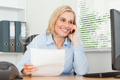 Portrait of a businesswoman looking up from a letter to her scre