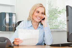 Portrait of a businesswoman looking up from a letter to her scre