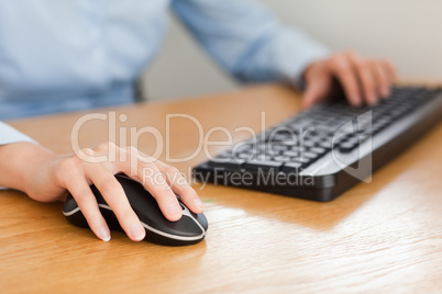 woman with hands on mouse and keyboard