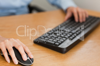 businesswoman with hands on mouse and keyboard