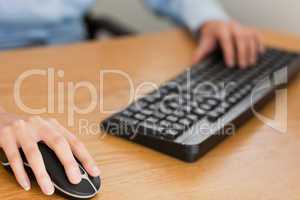businesswoman with hands on mouse and keyboard