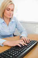 Typing woman looking at keyboard