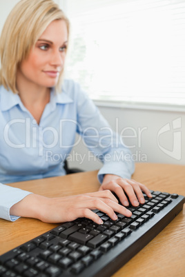 Typing woman looking at screen