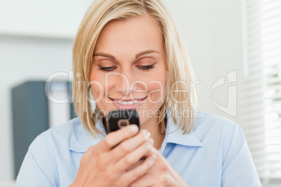 Smiling woman looking at her mobile